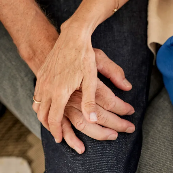 close-up image of two people holding hands