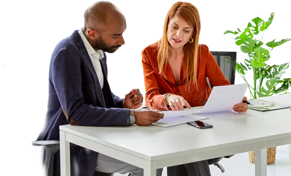 man and woman sitting at a table reviewing paperwork