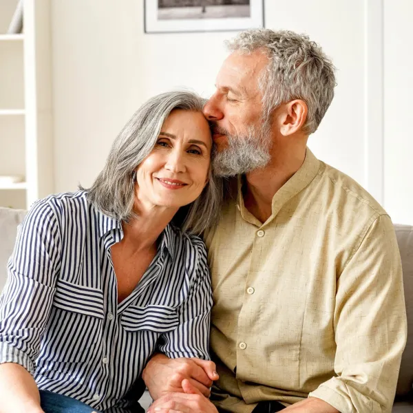 Older couple sitting together outside and looking off camera